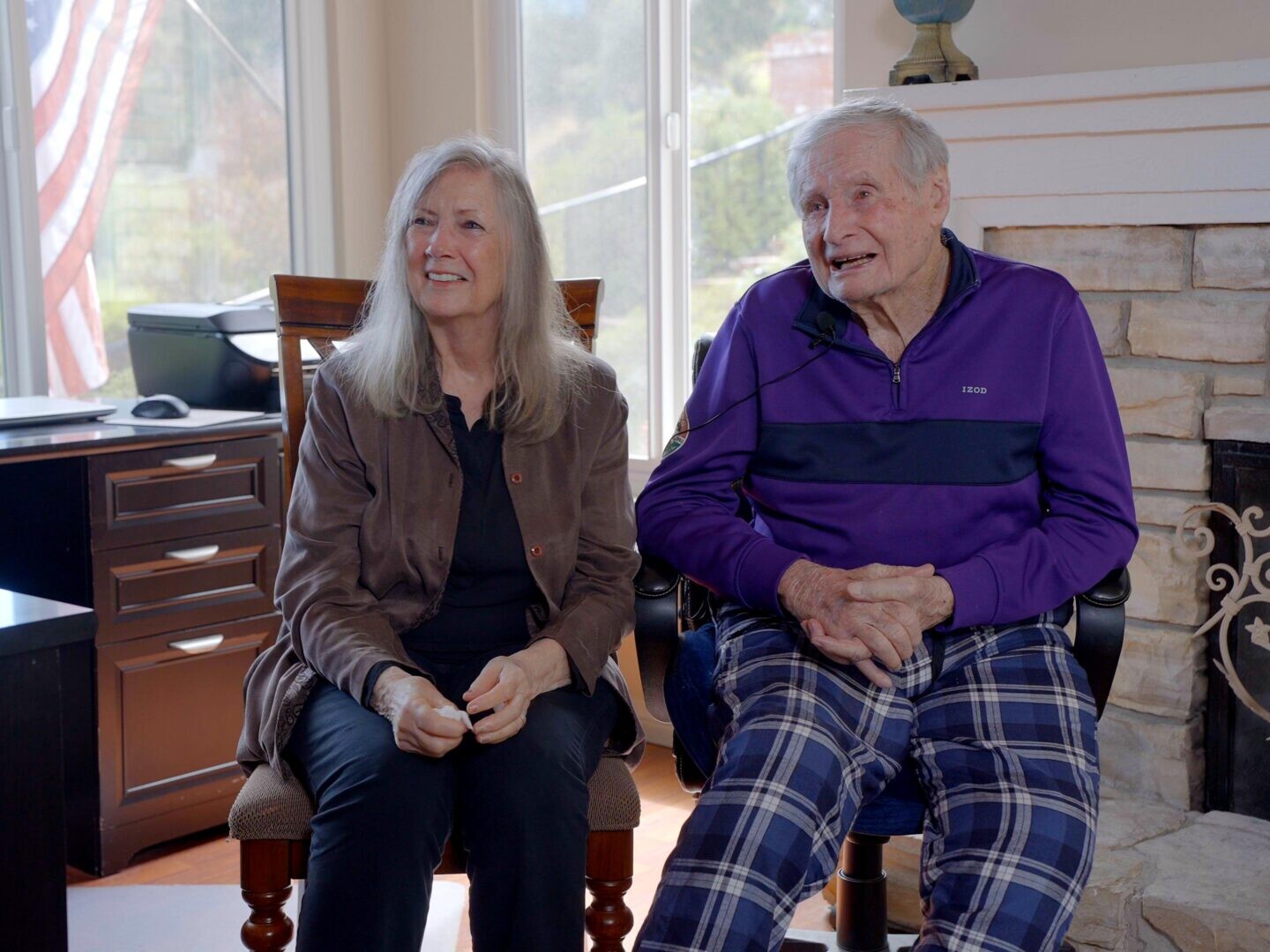 Healthcare workers conducting a home assessment with elderly patients, discussing hospice care criteria.