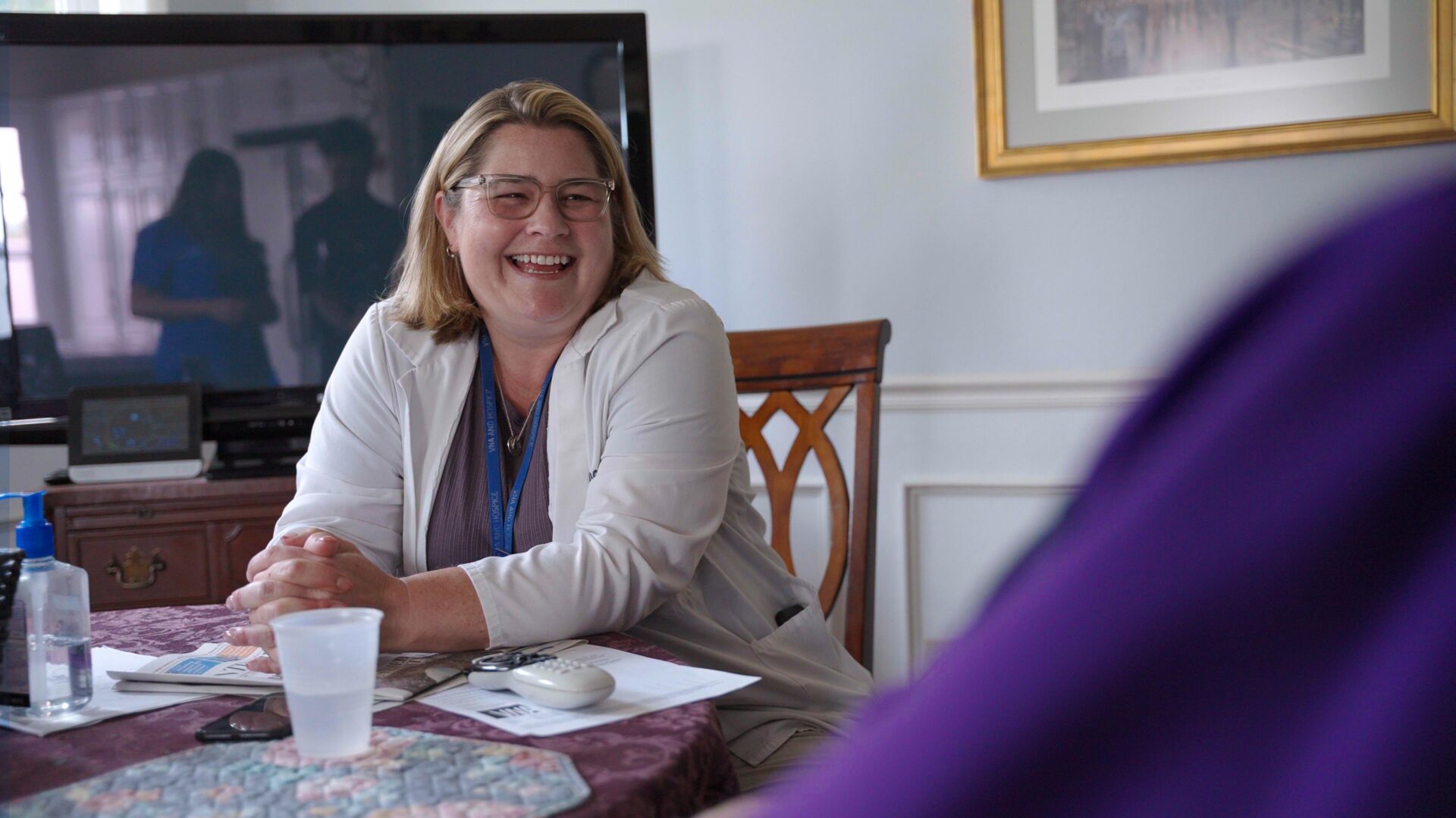 Healthcare professional consulting with patient at home during in-home speech therapy visit