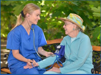 Nurse checking blood pressure of elderly patient during assessment and vital signs monitoring.