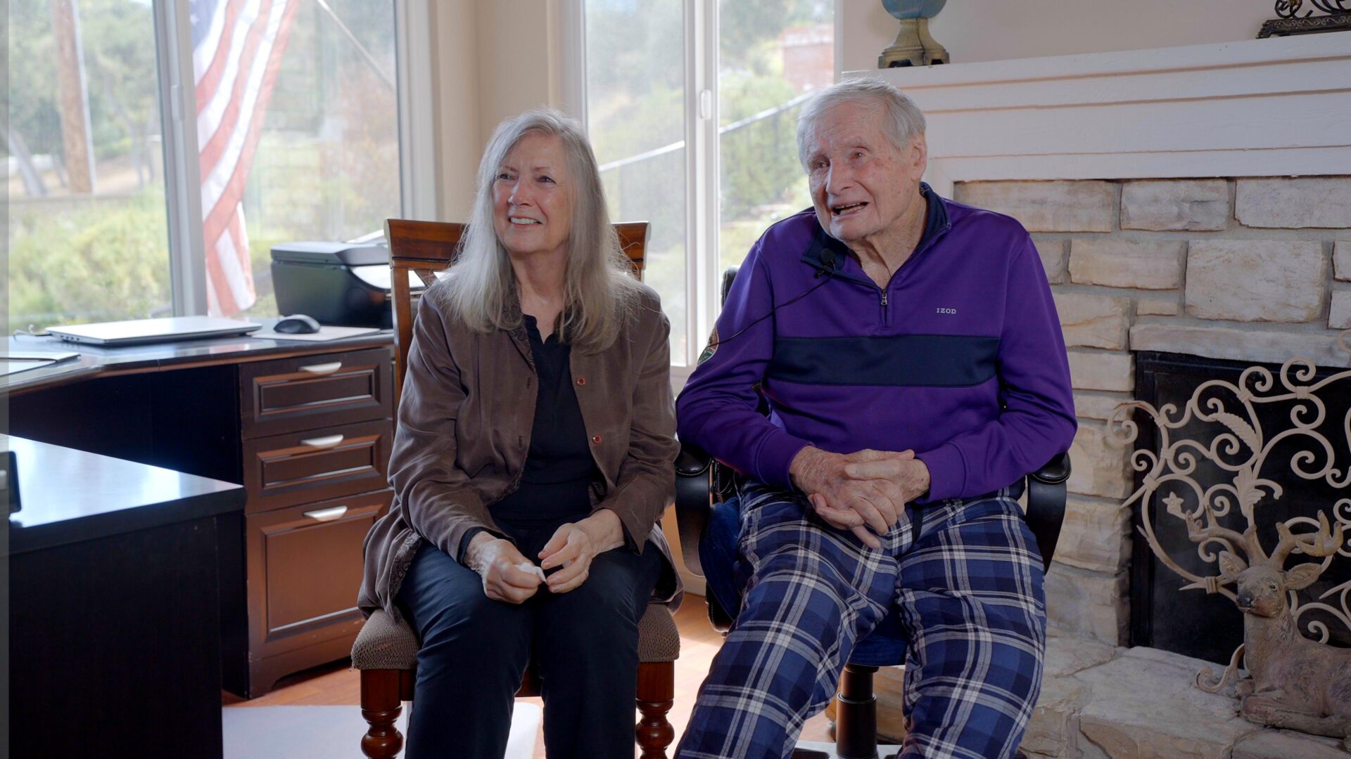 Healthcare workers assessing an elderly patient during a visit in a residential setting.